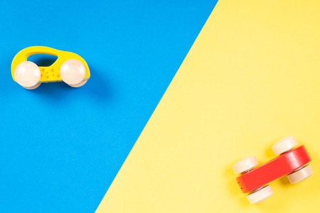 Two wooden toy cars on colorful backgroundの写真素材