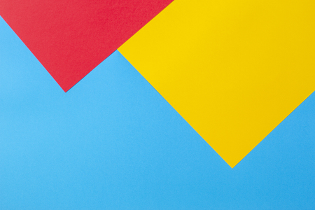 Color papers geometry flat composition background with yellow red and blue tonesの写真素材
