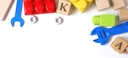 Colorful kid toys on white background. Top view, flat lay