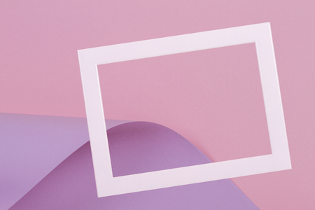 Blank empty white frame on colorful pink violet purple color paper backgroundの写真素材