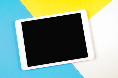Digital tablet computer on colorful background. Top view.の写真素材