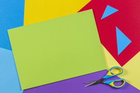 Top view of colored paper with colorful scissors. Kids art and craft paper applique backgroundの写真素材