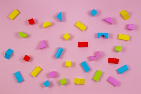 Colorful wooden building blocks on pink backgroundの写真素材