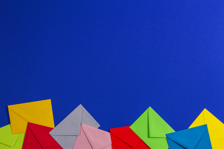 Colorful envelopes on blue background, top viewの写真素材