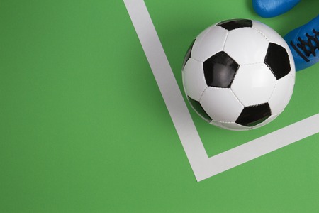 Soccer football player with soccer ball on green backgroundの写真素材