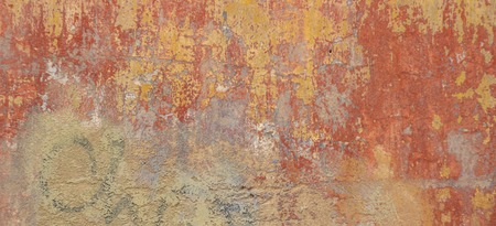 Old cracked weathered shabby red yellow painted plastered peeled wall banner background.