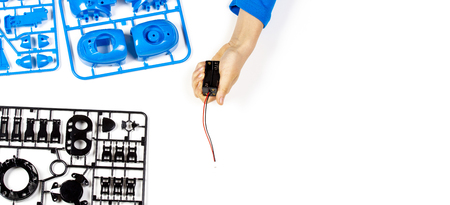 Child hands making robot car. Robotic, learning, technology, stem education for children background