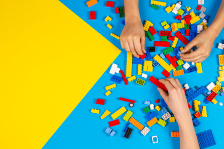 Vilnius, Lithuania - February 23, 2019. Children hands play with colorful lego blocks on the tableのeditorial素材