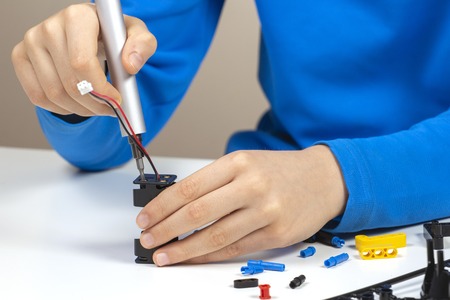 Child hands making robot car. Robotic, learning, technology, stem education for children backgroundの写真素材