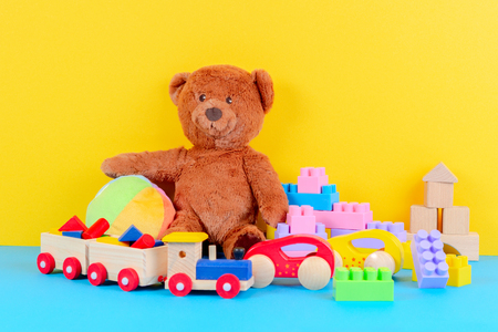 Baby kid toys collection on blue and yellow backgroundの写真素材