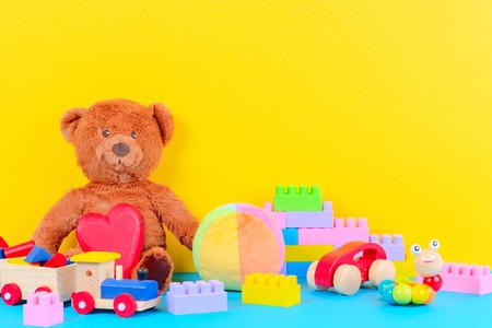 Baby kid toys collection on blue and yellow backgroundの写真素材