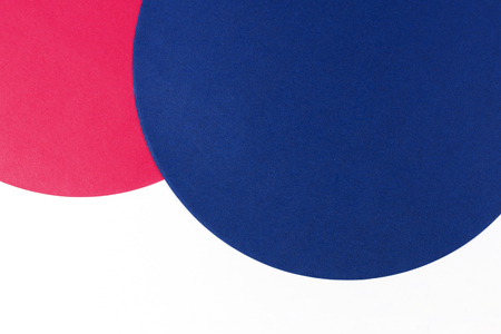 Abstract color paper background. Blue and pink color round circle shape geometry composition on white background. Top viewの写真素材