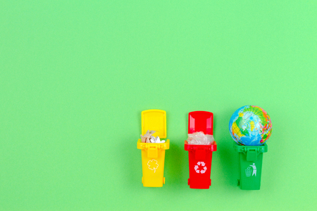 Ecology problem of environmental pollution planet, consumerism, recycling concept. Mini recycle bins...