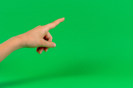Hand finger point on light green backgroundの写真素材