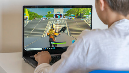 Vilnius, Lithuania - June 02, 2019: Boy playing Fortnite. Fortnite is online video game developed by Epic Gamesのeditorial素材