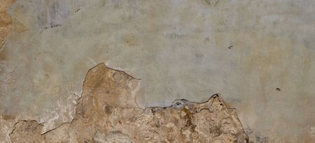 Old Wall With Peel Grey Stucco Texture. Retro Vintage Worn Wall Background. Decayed Cracked Rough Abstract Wall Surface.の写真素材
