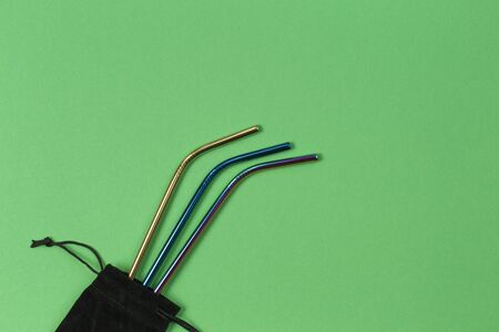 Environmental friendly stainless steel reusable drinking straws on green backgroundの写真素材