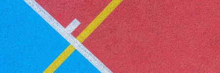 Colorful sports court background. Top view to red and blue field rubber ground with white and yellow lines outdoorsの写真素材