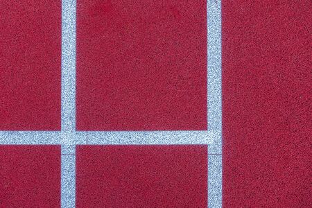 Colorful sports court background. Top view to red field rubber ground with white lines outdoorsの写真素材