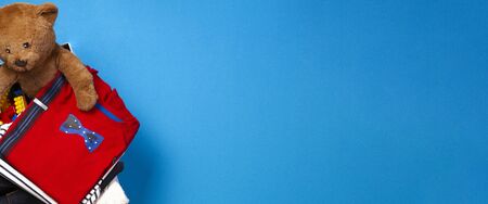 Donation box with clothing, books, children toys on blue background. Top viewの写真素材