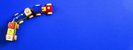 Wooden toy train with colorful blocks on blue background. Top viewの写真素材