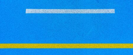 Colorful sports court background. Top view blue field rubber ground with white and yellow lines...