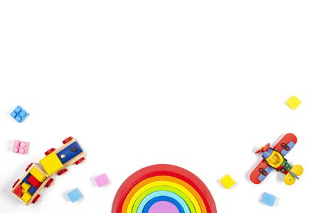 Baby kids toys background with wooden train, rainbow, plane and colorful blocks. Top view, flat layの写真素材