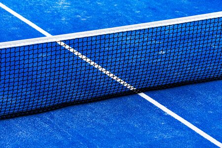 Blue paddle tennis court field with net background.の写真素材
