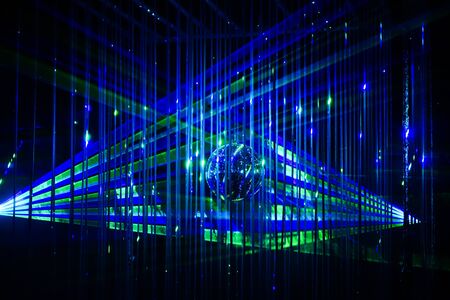 Green and blue laser beams on black background. Laser show rays stream.