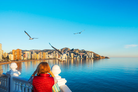 Benidorm Spain, December 25, 2019: Woman taking photo of beautiful Benidorm city views,...