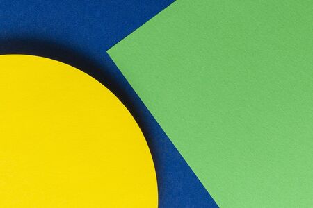 Abstract colored paper texture background. Minimal geometric shapes and lines in blue, green and yellow colors.の写真素材