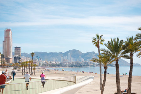 Benidorm, Spain - February 25, 2020: People enjoy sunny day in popular spanish resort Benidorm, Alicante, Spainのeditorial素材