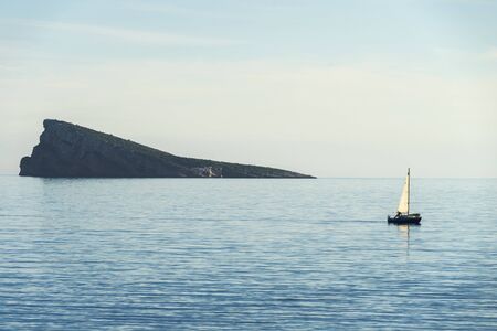Beautiful calm Mediterranean sea and Benidorm island in Benidorm, Spainの写真素材