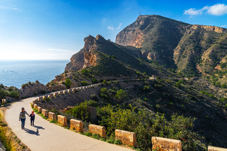 Albir, Spain - January 1, 2020 - Family enjoy the trip road to the lighthouse Albir in Sierra gelata...