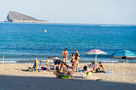 Benidorm, Spain - June 22, 2020: People relax in Poniente beach divided into plots. Popular spanish resort after Coronavirus pandemic lockdownのeditorial素材