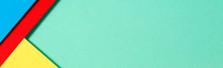 Abstract color papers geometry flat lay composition banner background with blue, yellow, red and...