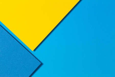 Abstract color papers geometry flat lay composition background with yellow and blue tonesの写真素材