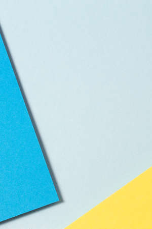 Abstract color papers vertical geometry flat lay composition background with blue, yellow color...
