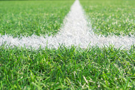 Green artificial grass turf soccer football field background with white line boundaryの写真素材
