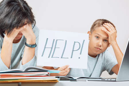 Learning difficulties, remote education, online learning concept. Tired mother and sad kid need help...