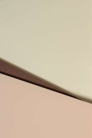 Abstract color papers geometry composition background with yellow, beige and brown tones