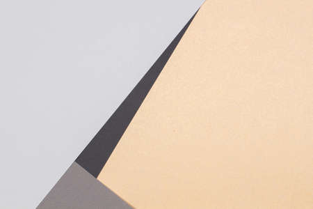 Creative abstract geometric paper background light gray, black colors and brown craft paper. Top view. Copy spaceの写真素材