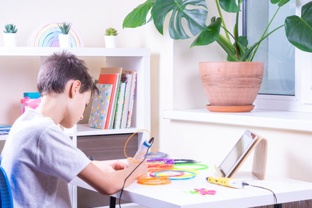 Child creating new 3d object with 3d pen. Learning and entertainment at home