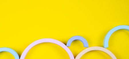 Wooden geometric shapes colorful figures composition on yellow