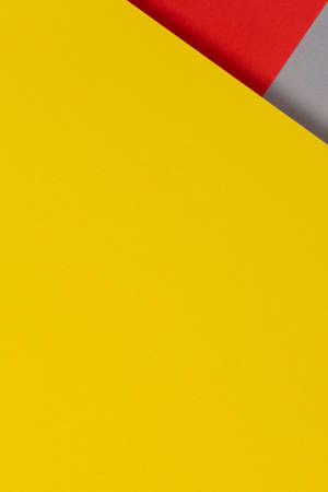 Creative abstract yellow, red and gray color geometric paper compositon background, top viewの写真素材