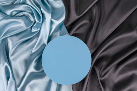 Geometric platform podium on light blue silk satin background. Blank minimal cylinder form mock up...