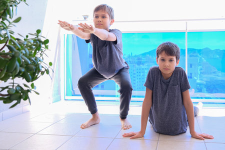 Boys doing sport exercises on balcony. Sport, healhty lifestyle, active leisure at homeの写真素材