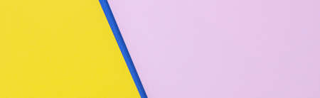 Creative abstract blue, pink and yellow color geometric paper compositon background, top viewの写真素材