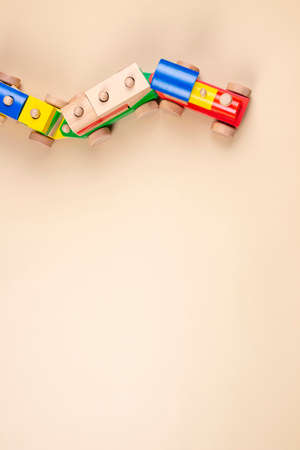 Wooden toy train with multi colored blocks on pastel beige background. Top viewの写真素材