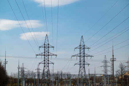 High voltage electric pylon and electrical wire with blue sky background. High voltage grid tower...